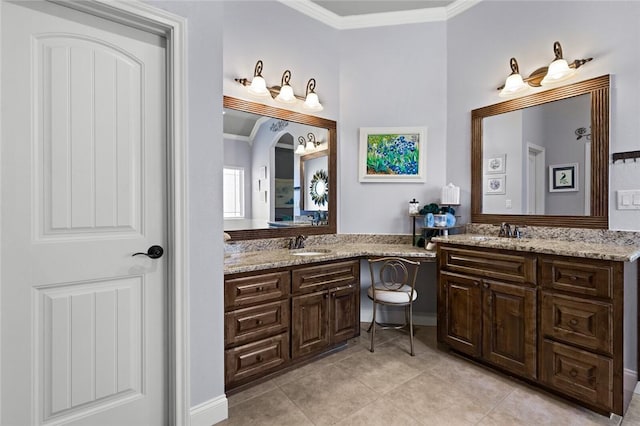 bathroom with tile patterned floors, vanity, and crown molding