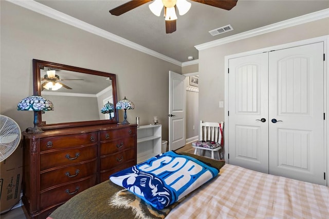 bedroom with a ceiling fan, visible vents, a closet, and ornamental molding