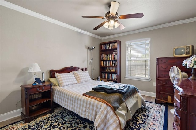 bedroom with ornamental molding, a ceiling fan, baseboards, and wood finished floors