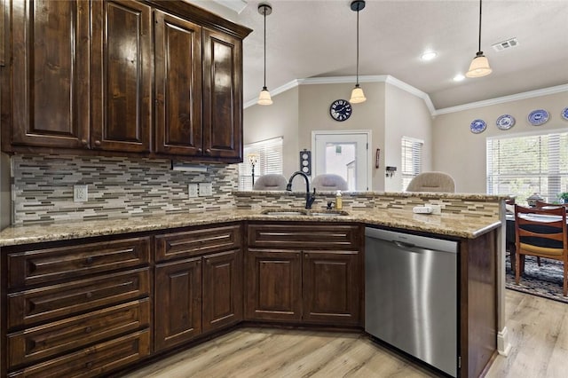 kitchen featuring a sink, visible vents, stainless steel dishwasher, and hanging light fixtures