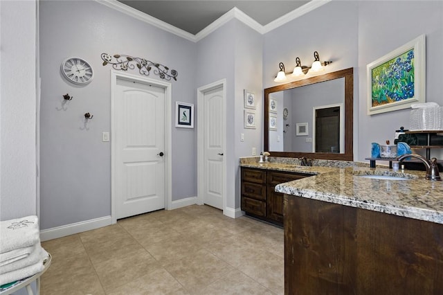 bathroom featuring tile patterned floors, baseboards, crown molding, and vanity