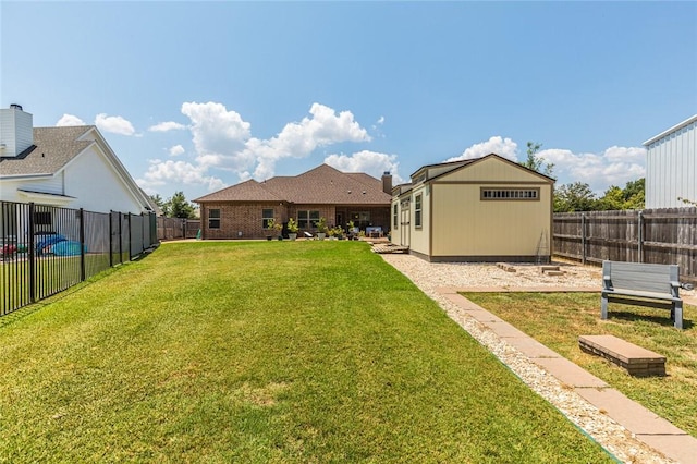 view of yard featuring a fenced backyard and an outdoor structure