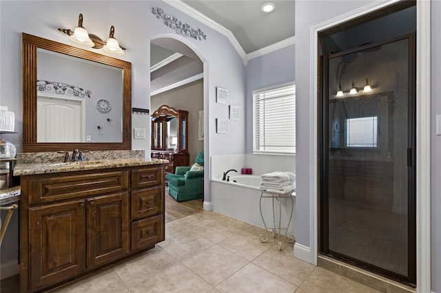 bathroom featuring tile patterned floors, ornamental molding, a bath, and vanity