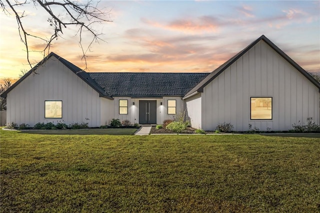 modern inspired farmhouse featuring a yard