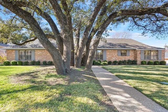 ranch-style home with a front lawn