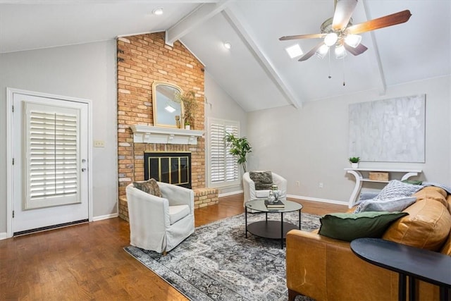 living room with a fireplace, ceiling fan, vaulted ceiling with beams, and dark wood-type flooring