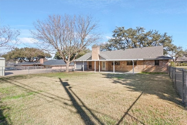 rear view of house featuring a lawn