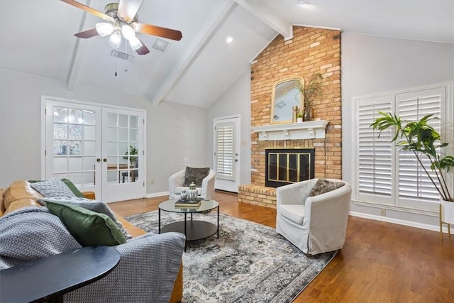 living room featuring lofted ceiling with beams, dark hardwood / wood-style floors, french doors, a fireplace, and ceiling fan