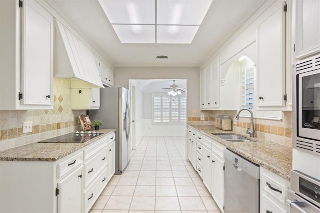 kitchen featuring sink, white cabinets, ceiling fan, and stainless steel appliances