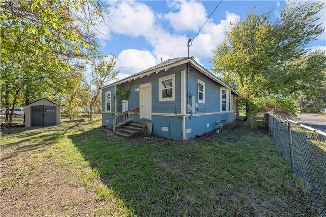 exterior space with a yard and a storage unit