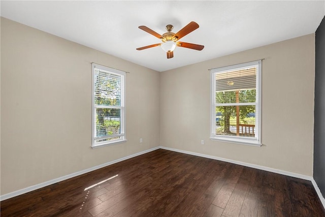 empty room with ceiling fan and dark wood-type flooring