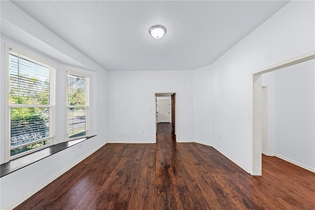 spare room with dark hardwood / wood-style flooring