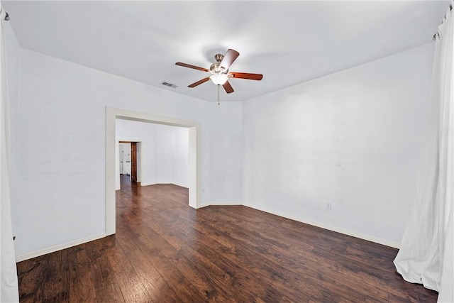 spare room with ceiling fan and dark hardwood / wood-style flooring