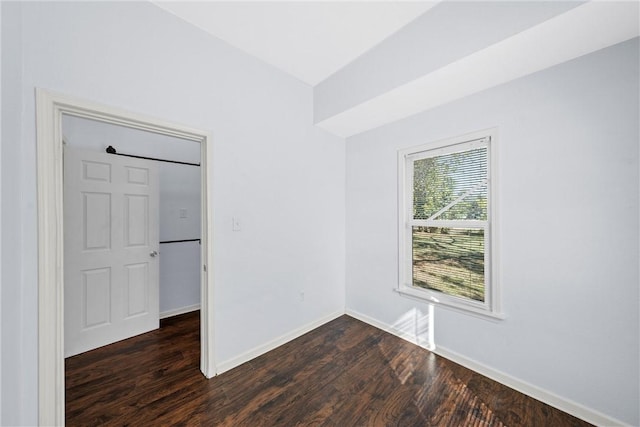 unfurnished room featuring dark wood-type flooring