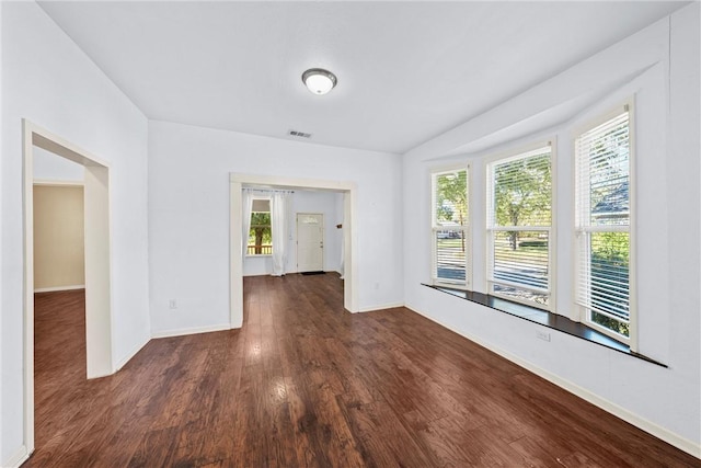 spare room featuring dark hardwood / wood-style floors