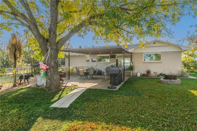 back of house featuring a yard and a patio