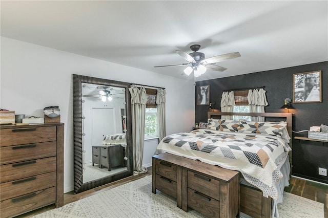 bedroom featuring light hardwood / wood-style floors and ceiling fan