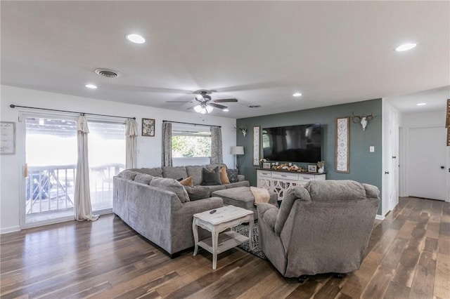 living room with ceiling fan and dark wood-type flooring