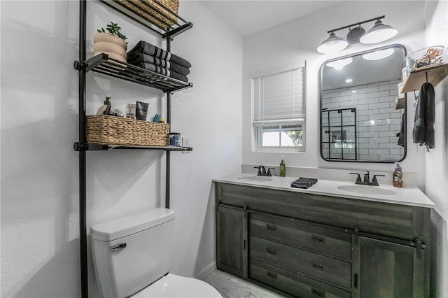 bathroom featuring vanity and toilet