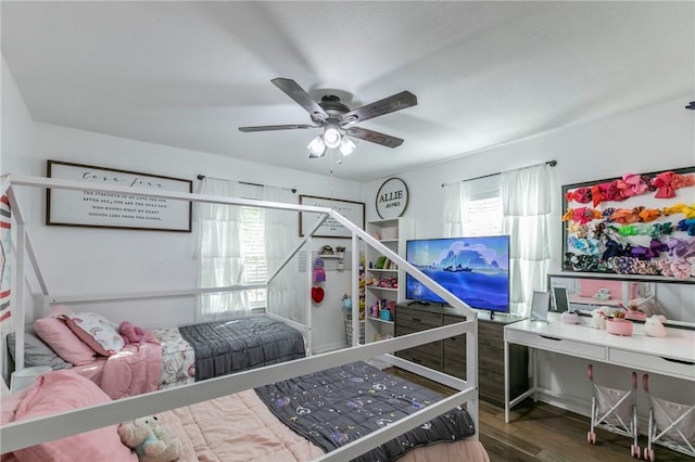 bedroom with ceiling fan and dark wood-type flooring