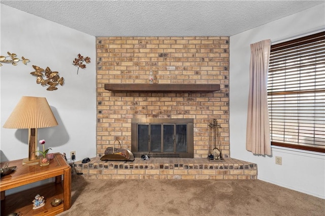 carpeted living room featuring a fireplace and a textured ceiling