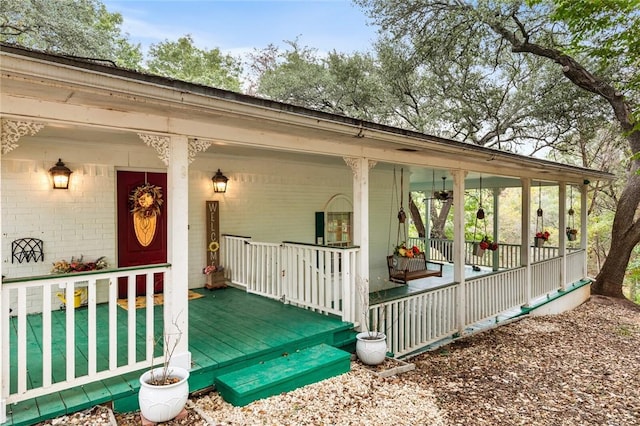 view of exterior entry with a porch