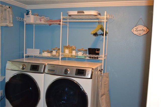 laundry area featuring washing machine and dryer and ornamental molding