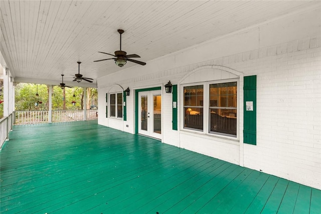 wooden deck with ceiling fan and french doors