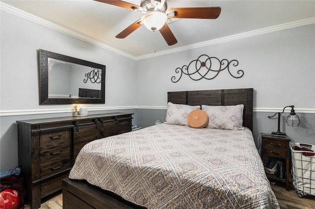 bedroom with ceiling fan, ornamental molding, and wood-type flooring