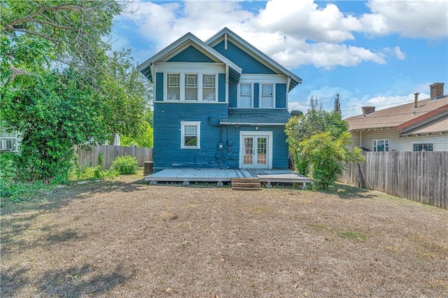 back of property with a deck and french doors