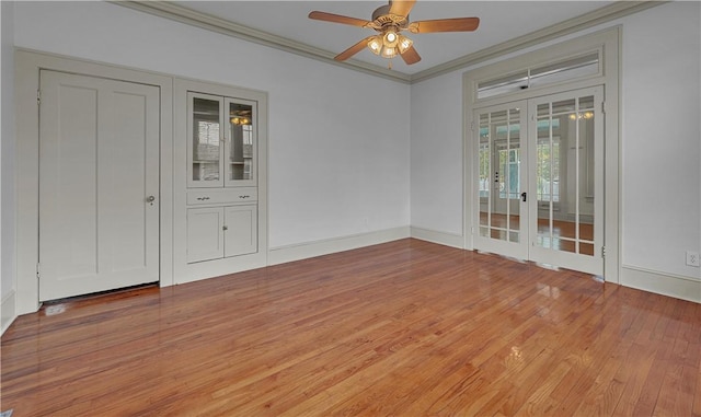 spare room featuring crown molding, french doors, ceiling fan, and hardwood / wood-style floors