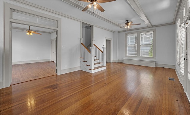 unfurnished living room with beamed ceiling, hardwood / wood-style floors, ceiling fan, and ornamental molding