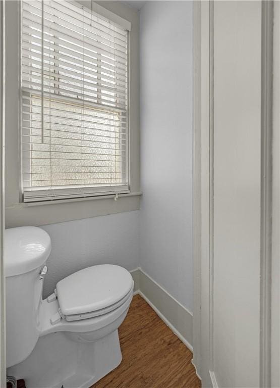 bathroom featuring hardwood / wood-style flooring and toilet