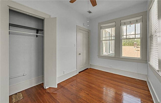 unfurnished bedroom featuring a closet, ceiling fan, and hardwood / wood-style floors