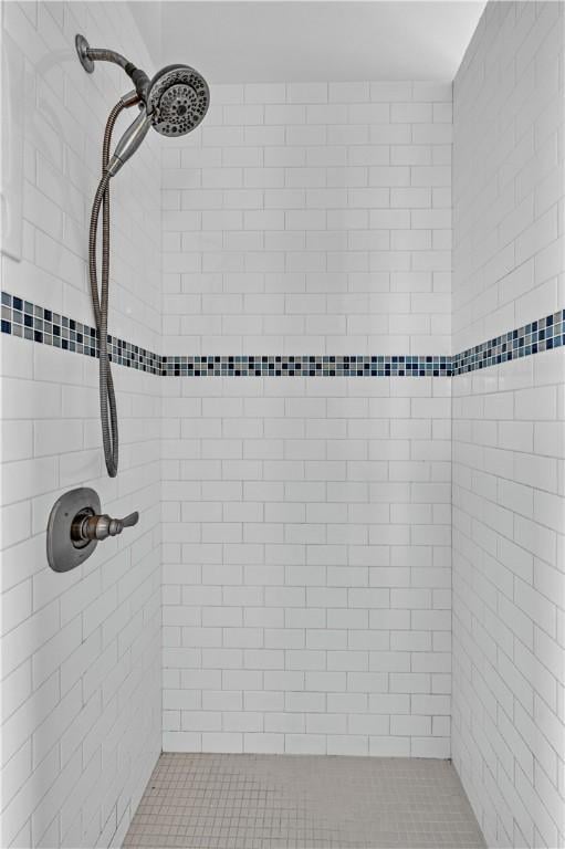 bathroom featuring a tile shower and tile patterned floors