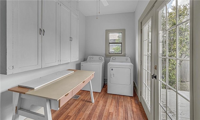 laundry area with cabinets, french doors, ceiling fan, light wood-type flooring, and washing machine and clothes dryer