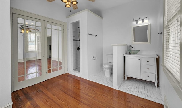 bathroom featuring plenty of natural light, vanity, wood-type flooring, and french doors