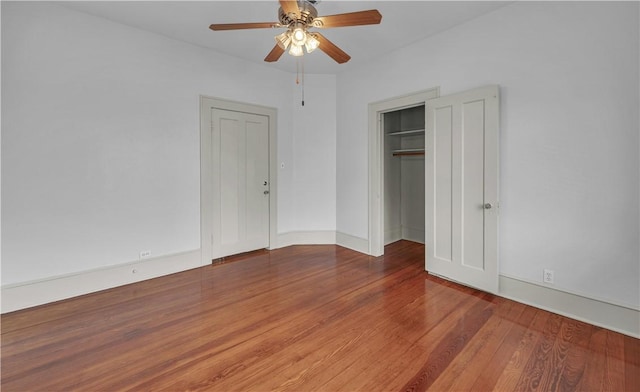 unfurnished bedroom with ceiling fan and wood-type flooring