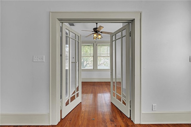 hall with french doors and wood-type flooring