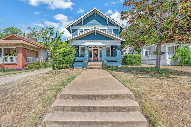 view of front facade with covered porch and a front yard