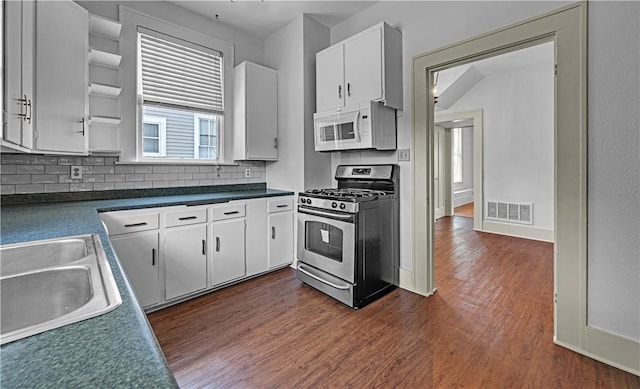 kitchen featuring sink, stainless steel gas stove, decorative backsplash, dark hardwood / wood-style flooring, and white cabinetry