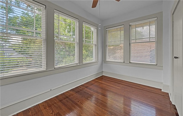 unfurnished sunroom featuring ceiling fan