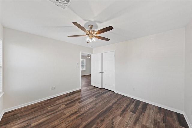 unfurnished room featuring ceiling fan and dark hardwood / wood-style flooring