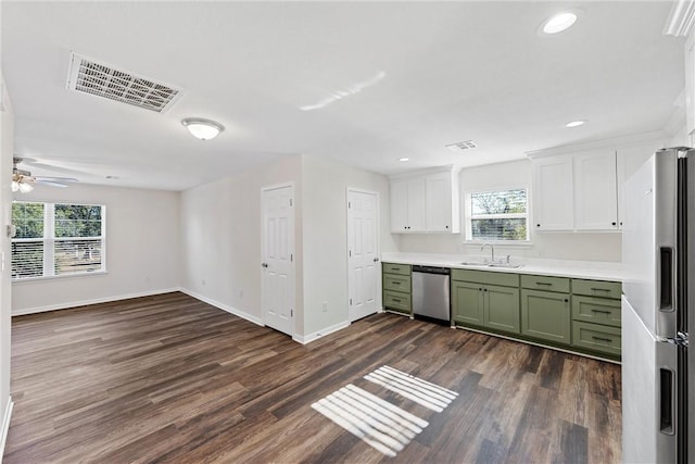 kitchen with dark wood-type flooring, stainless steel appliances, plenty of natural light, and green cabinets