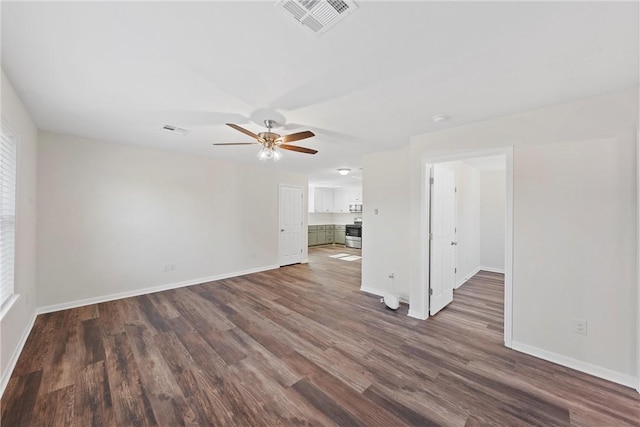 unfurnished living room with ceiling fan and dark wood-type flooring