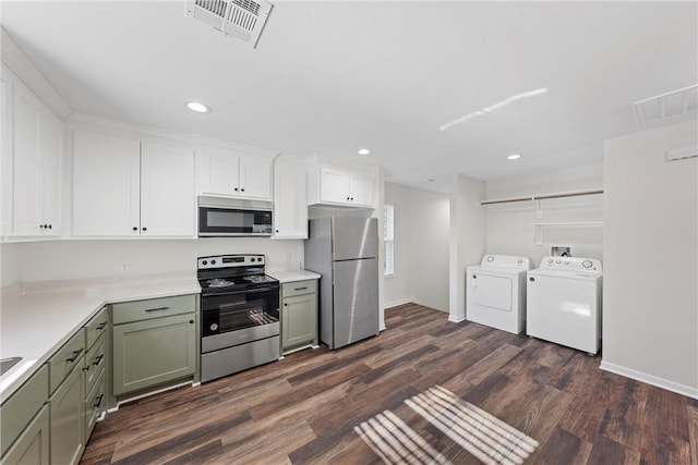 kitchen with stainless steel appliances, separate washer and dryer, dark hardwood / wood-style flooring, white cabinets, and green cabinetry