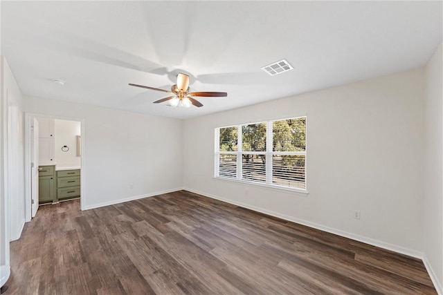 unfurnished bedroom with connected bathroom, ceiling fan, and hardwood / wood-style flooring