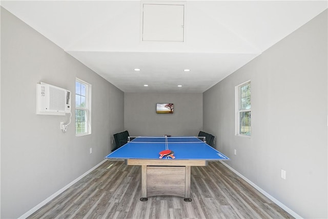 game room with plenty of natural light and light hardwood / wood-style flooring