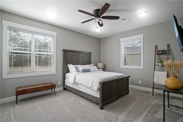 bedroom featuring carpet flooring, multiple windows, and ceiling fan