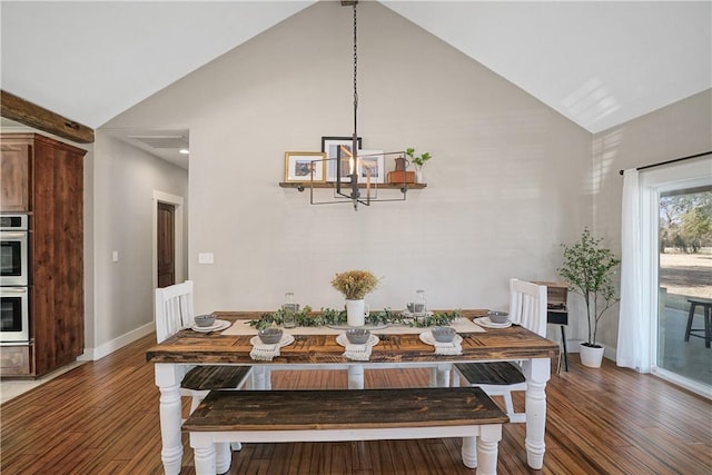 dining room with a notable chandelier, dark hardwood / wood-style flooring, and high vaulted ceiling